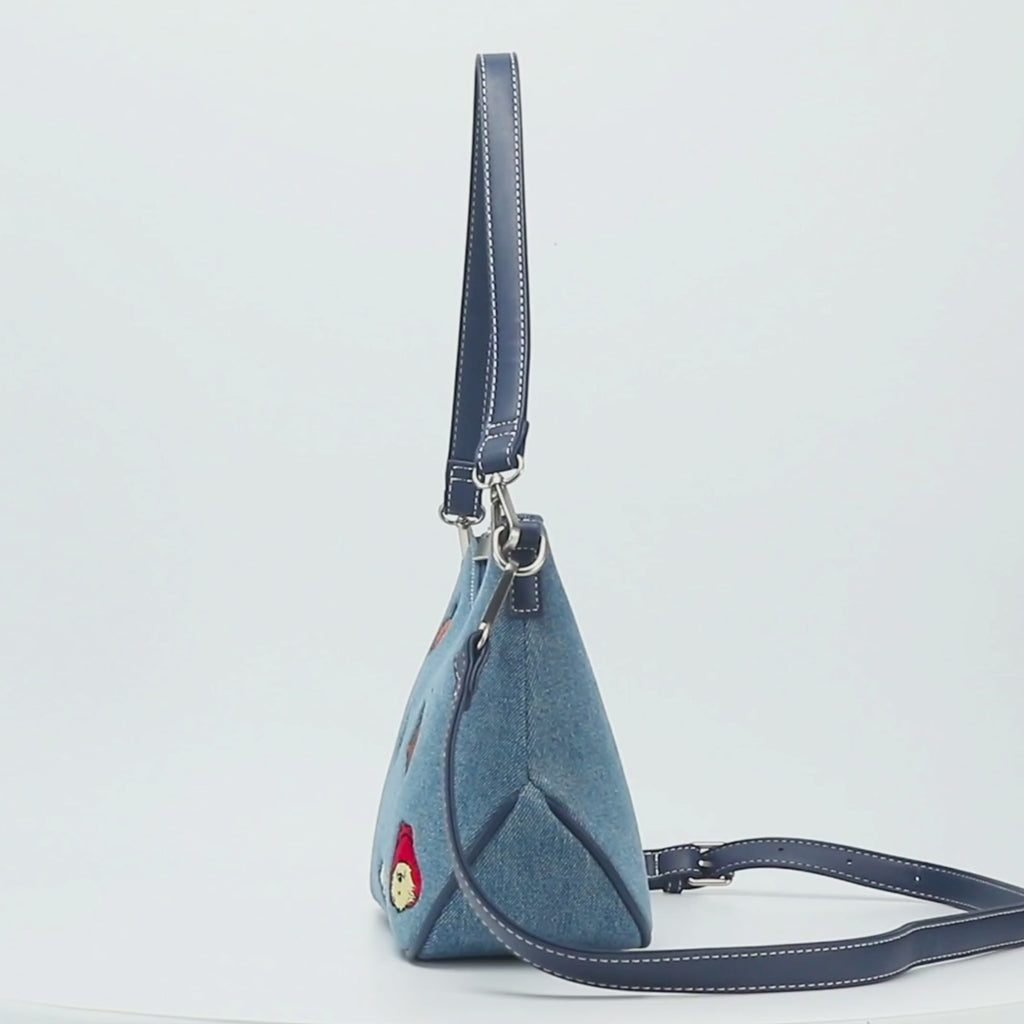 Paddington P.B. Collection denim shoulder bag handbag with adjustable strap, zip fastening and silver-tone hardware shown in close-up detail.