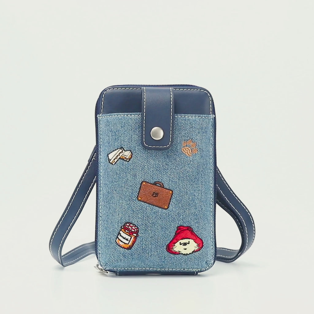 Paddington P.B. Collection denim phone bag with adjustable crossbody strap and Paddington detailing shown in close-up.