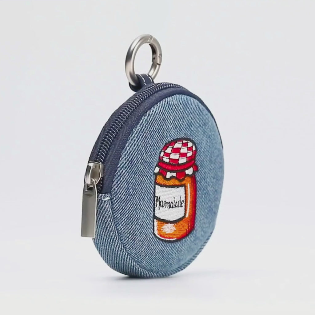 Paddington P.B. Collection denim bubble purse featuring a playful marmalade jar design and zip fastening shown in close-up.