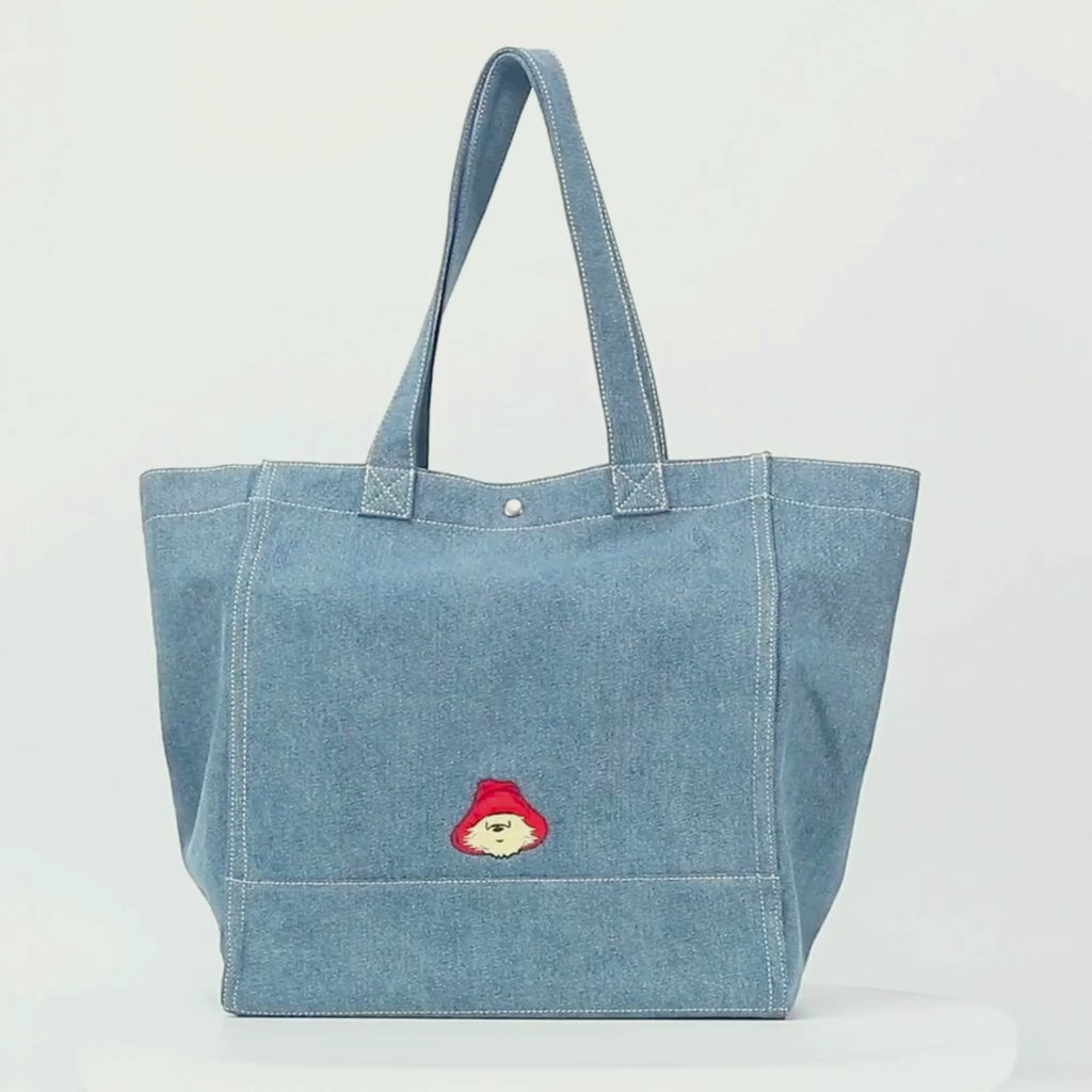 Paddington P.B. Collection oversized denim tote bag with shoulder straps, spacious interior and Paddington detailing shown in close-up.