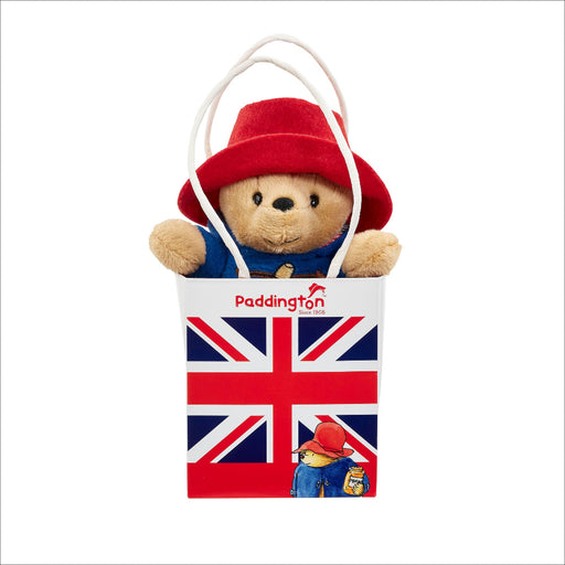 Paddington bear plush toy in a bag with a Union Jack design on a white background