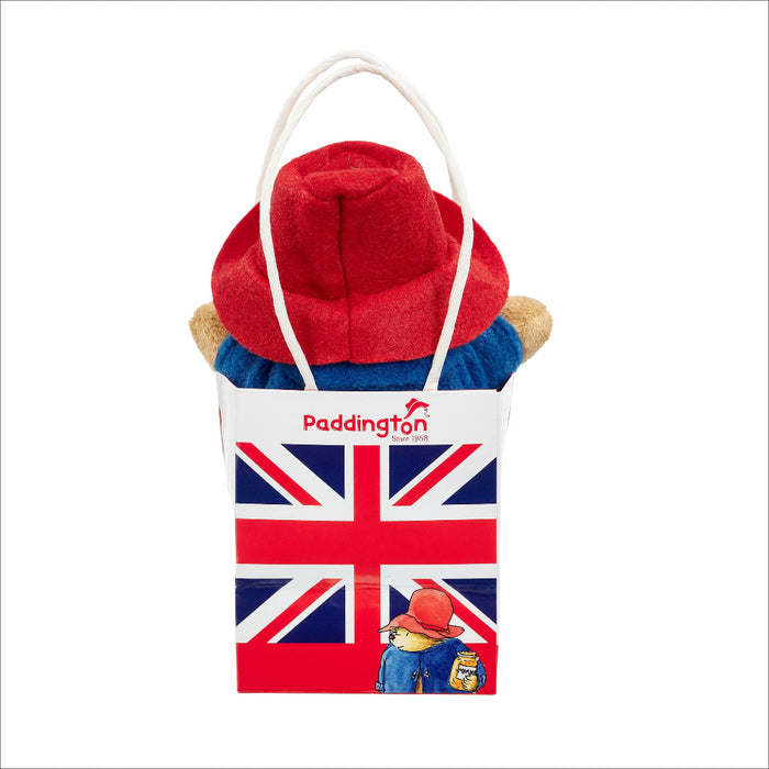 Paddington Bear plush toy with a Union Jack bag on a white background
