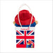 Paddington Bear plush toy with a Union Jack bag on a white background