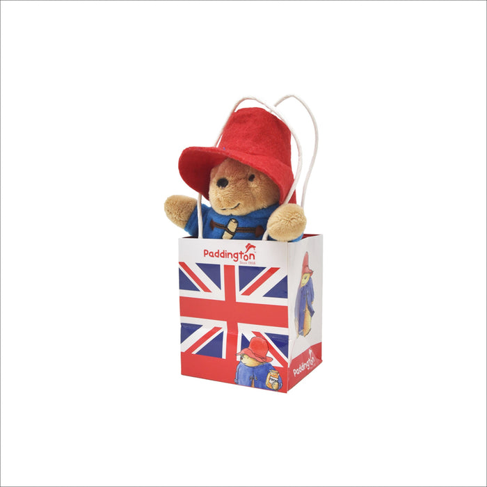 Plush Paddington bear in a Union Jack gift bag on a white background