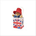Plush Paddington bear in a Union Jack gift bag on a white background