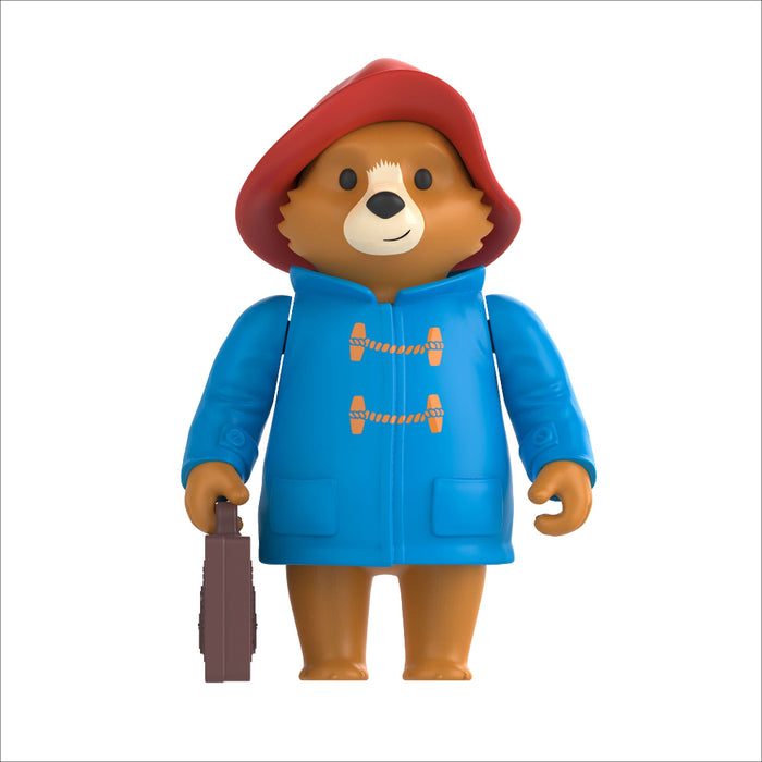 Toy figure of Paddington bear in a blue raincoat with a red hood on a white background